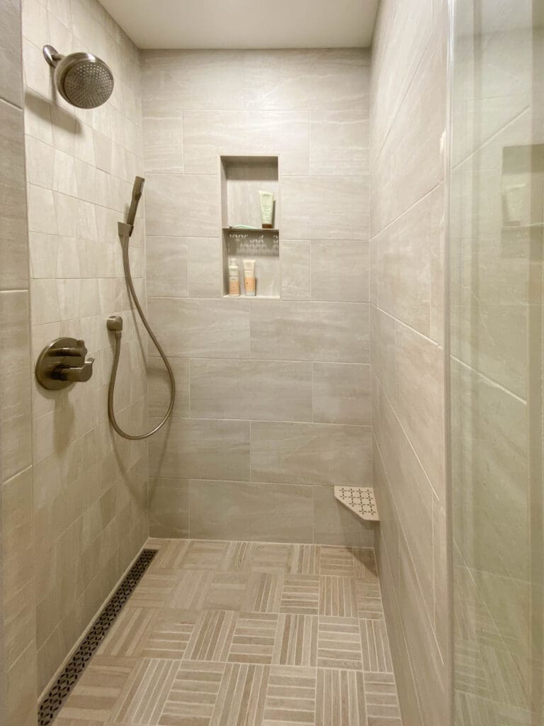 Shower remodel with a double niche and a foot step.